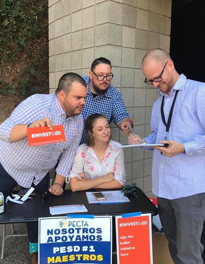 Inspired by the #RedForEd movement, Carlos “Chico” Robinson (left) and Jay Barbuto (center) are among new leadership at a Phoenix union who helped turn a once small and passive local into a powerhouse.
