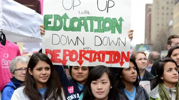 Protesters holding Up with Education Down with Deportation at NC student rally