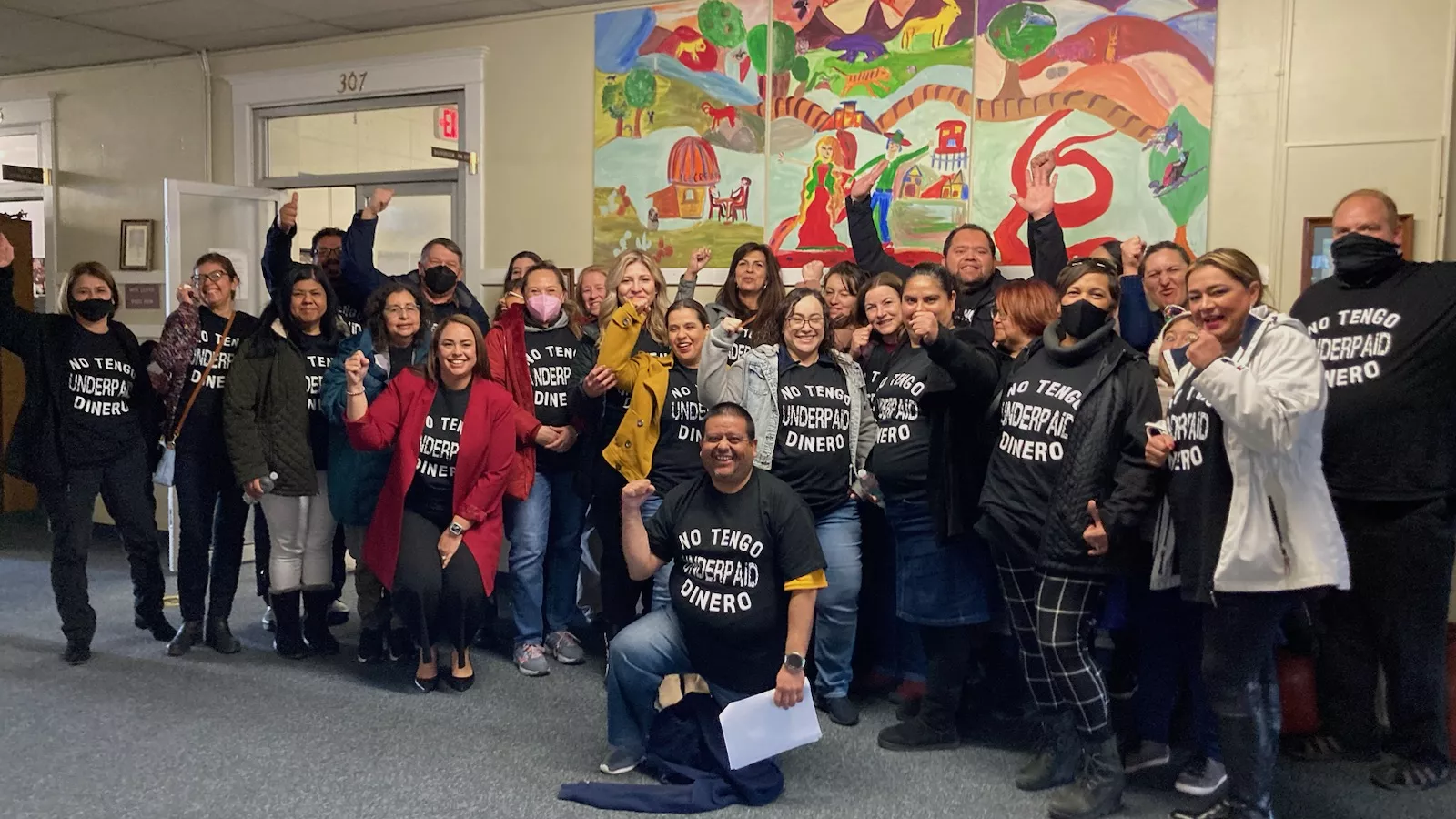 Group of educators wearing matching T-shirts that say "Underpaid"